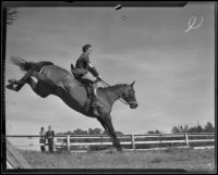 James A. Gough and horse “Judith” clear a hurdle at the Flintridge Riding Club, Flintridge, 1936