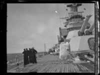 A group of sailors on the deck of a US Navy battleship