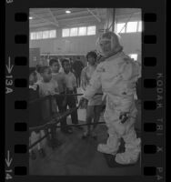 TRW Systems' employee showing school children model of Apollo astronauts' space suit at Space and Science Show in Los Angeles, Calif., 1969