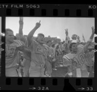 John Lee and other UCLA football players on sideline after win, 1984