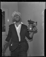 Prince Ucon holds a blowtorch for demonstration, Lincoln Heights, 1936