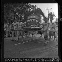 University of Southern California Kappa Alpha fraternity men carrying a Volkswagen Beetle in "Volks-toting" race, 1964