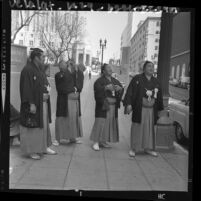 Four Japanese Sumo wrestlers in traditional garb on sightseeing walk in downtown Los Angeles, 1964