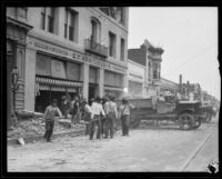 Workers clearing rubble from earthquake-damaged buildings on a commercial street, Santa Barbara, 1925