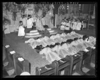 St. John's Seminary students prostrated before altar as they are being ordained in Los Angeles, Calif., 1943