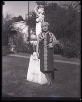 Millicent Sunday Standing in front of a garden statue in a park or yard, Los Angeles, 1928