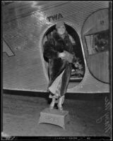 Mary McCormick standing at an open airplane door, Los Angeles, circa 1935