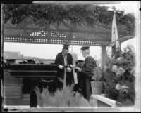 Rufus B. Von Kleinsmid awarding a diploma, University of Southern California graduation, Los Angeles Memorial Coliseum, Los Angeles, 1932