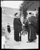 Frank C. Touton awarding diploma to his daughter, Harriet Louise Touton, University of Southern California graduation, Los Angeles Memorial Coliseum, Los Angeles, 1934