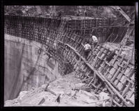 Workers walking on the face of Santa Anita Dam during construction, Los Angeles County, 1926