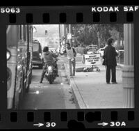 Postal worker Gregory Frazier taking income tax returns from passing motorists on Alameda Avenue in Los Angeles, Calif., 1980