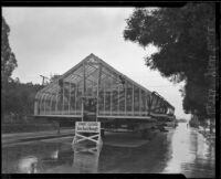 Greenhouse for the estate of Arthur Letts, Jr., as it is transported on a residential street, Los Angeles, circa 1927