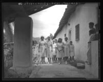 Girls in white veils, on their way to Pala mission chapel to join in the religious procession, Calif., 1938