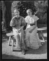 Elizabeth Sinclair and Susie Isabell Ackerman sit on a bench, 1935