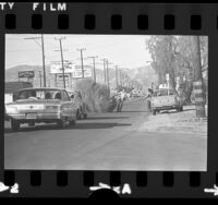 Man removing huge tumbleweed from Lankershim Blvd. in North Hollywood, Calif., 1974