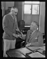 Joe Taylor gives Captain Carl R Williams a police badge to honor his retirement, Los Angeles, 1935