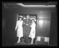 Corporal William W. LeSueur, Lieutenant Anne Wojcik, and Lieutenant Thekla Lennon exiting a hospital train, Van Nuys, 1944