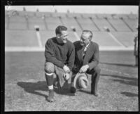 Football player Red Grange and manager C.C. Pyle posing, Los Angeles Coliseum, Los Angeles, 1926