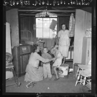 Plights of Americans and Braceros Compared:Betty Rush, sits in cabin at Woodville Farm Labor Center, Calif., 1961