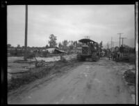 Tractor and relief workers on a muddy road in area devastated the flood following the failure of the Saint Francis Dam, Santa Clara River Valley (Calif.), 1928