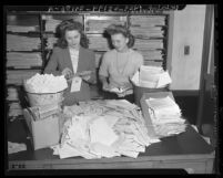 Two Los Angeles Times employees opening letters from readers who responded to the "Jap questionnaire," 1943