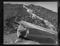 Blast-damaged Los Angeles Aqueduct pipes lie on a hillside in No-Name Canyon, Inyo County vicinity, [about 1927]