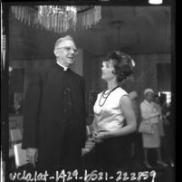 Actress Gigi Perreau chatting with Cardinal James Francis McIntyre at entertainment industry communion breakfast, Calif., 1964