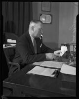 Los Angeles police detective Joe Taylor working at desk, 1931