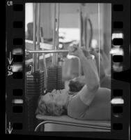 Senior citizen working out on weight machine at L.A. Athletic Club, 1966