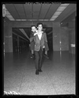 Jerry Mathers (a.k.a. Little Beaver), rides out of courtroom on the back of his TV show brother, Tony Dow