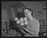 Frances Lee Bussey with a basket of oranges, San Bernardino, 1936