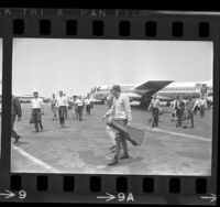 California National Guardsmen, San Fernando unit, in street clothes, existing plane in Los Angeles, Calif., 1968