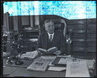 Judge Edward I. Butler seated at his desk, Los Angeles, 1929