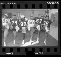 Six Los Angeles Rams players performing a kick line dance, Calif., 1975