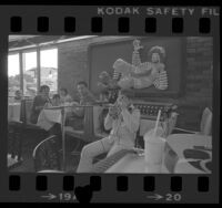 Twelve-year-old Rick Ludt playing Jew's harp at a McDonald's Big Mac Supper Club in Pasadena, Calif., 1976