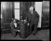 Investigators Chester Horn and Ben Cohn investigate a trunk alledgedly owned by Kenneth G. Ormiston, Los Angeles, 1926