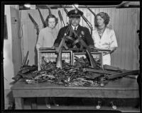 Police Mona Rehling, James E. Davis, and Mabel D. Stevens show weapons ready for disarmament, Los Angeles, 1935