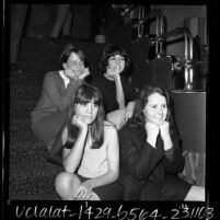 Four women seated on stairs at Dave Hull's Hullabaloo club on Sunset Blvd. in Los Angeles, Calif., 1965