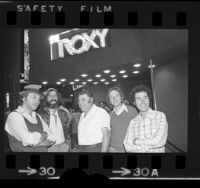 Bill Graham, Lou Adler, Chuck Landis, Elliot Roberts and David Geffen standing under the Roxy nightclub marquee in Los Angeles, Calif., 1973