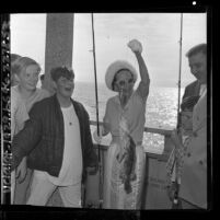 Los Angeles Parks Commissioner Dorothy Morton holding fish she caught at Venice fishing pier opening, 1965