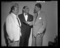 Ronald Reagan presents Attorney Laurence W. Beilenson with an honorary gold membership to the Screen Actors Guild as Edward Arnold watches, 1949