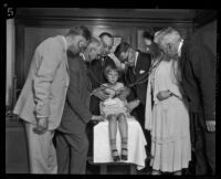 Dr. Sven Lokrantz and a group of doctors examine a child, Los Angeles, 1927