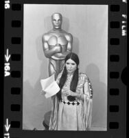 Sacheen Littlefeather standing before Oscar statue holding Marlon Brando's statement at the 45th annual Academy Awards in Los Angeles, Calif., 1973