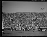 Alabama's Jimmy Angelich carries the ball through the Stanford defense during the Rose Bowl, Pasadena, circa 1935