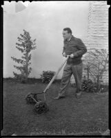 Boxer Jimmy McLarnin mows his lawn, Beverly Hills, 1936