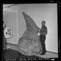 Artist Claes Oldenburg with artwork depicting 11-foot tall ice cream cone in Venice, Calif., 1963