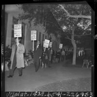 Teachers with placards reading "collective bargaining" marching outside Los Angeles Board of Education, 1964