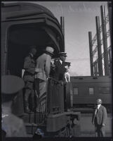 Commander Richard Byrd and his expedition members stand at the back of a train car, Los Angeles, 1928