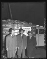 Ben R. Pitcher, James J. Mauget and A. Harry Eisenberg of Los Angeles Jewish Community Council standing beside truck with donated food, 1949