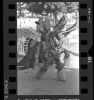 Two men performing the Eagle Dance at dedication of Indian Garden at the El Pueblo State Historic Park in Los Angeles, 1986